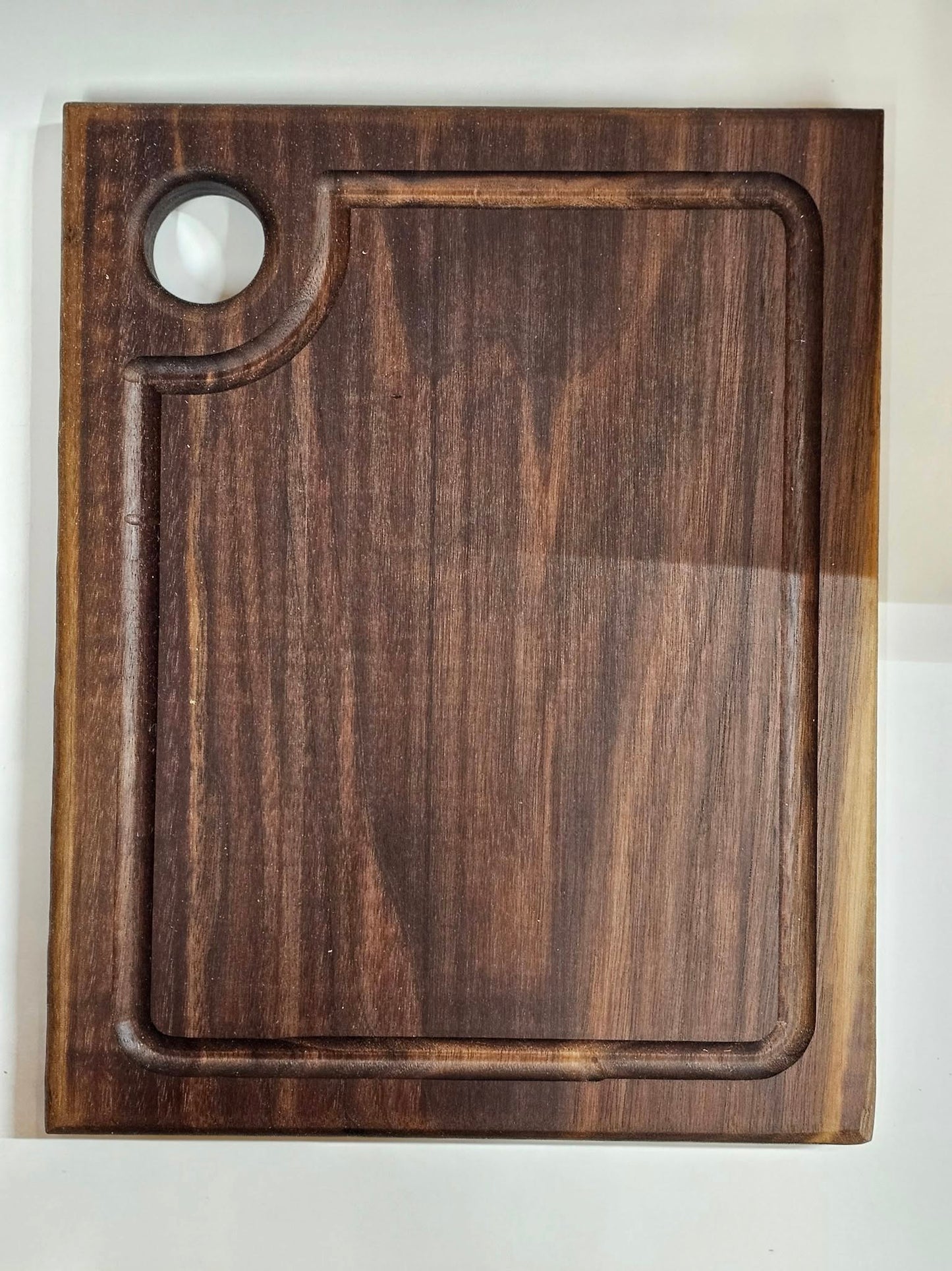 Dark American walnut cutting board. Medium size