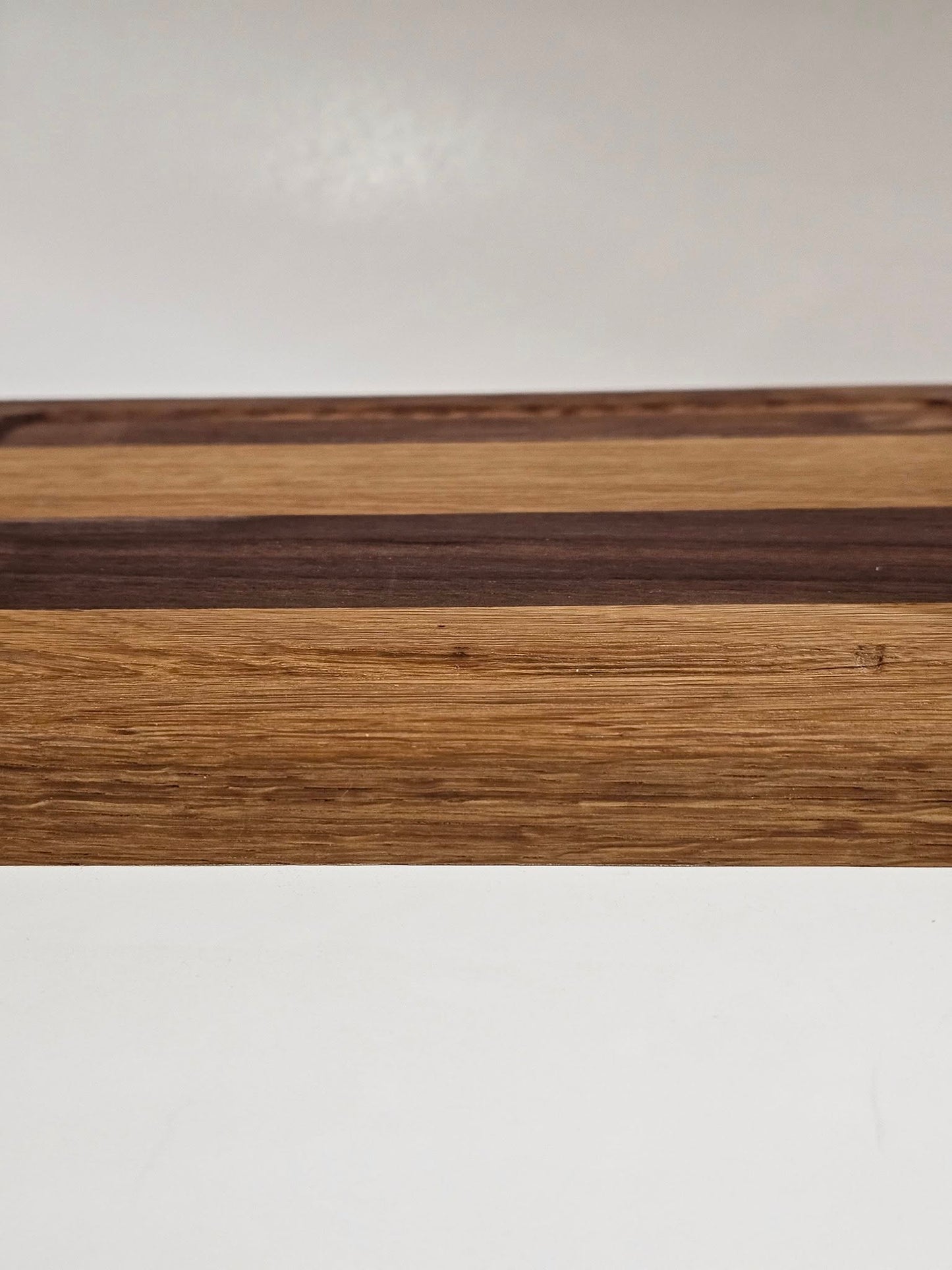 Dark American walnut and white oak cutting board. Small