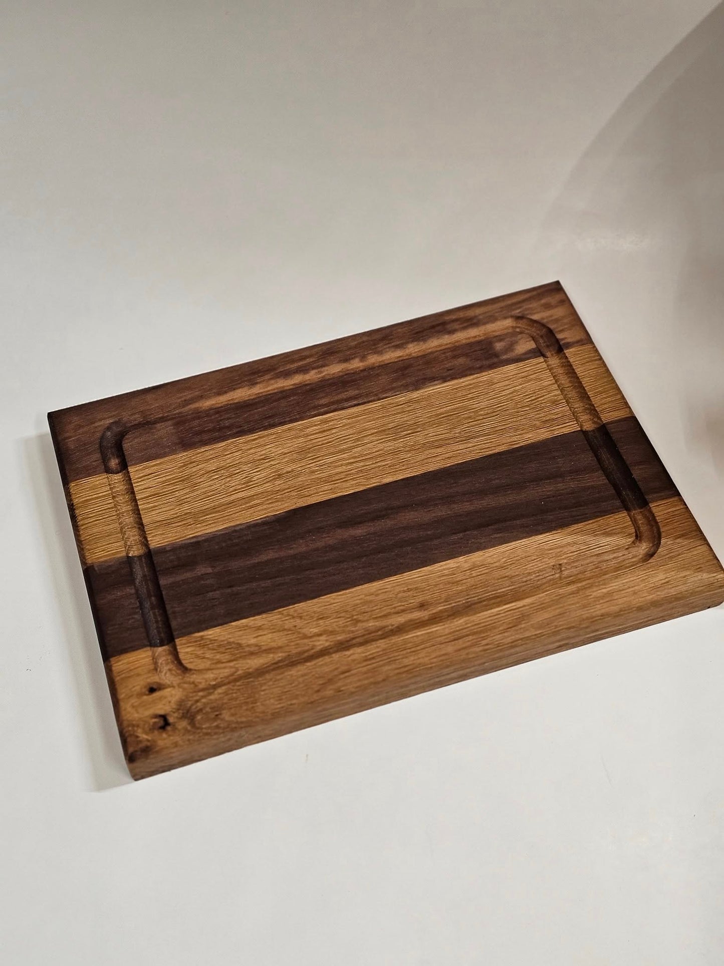 Dark American walnut and white oak cutting board. Small