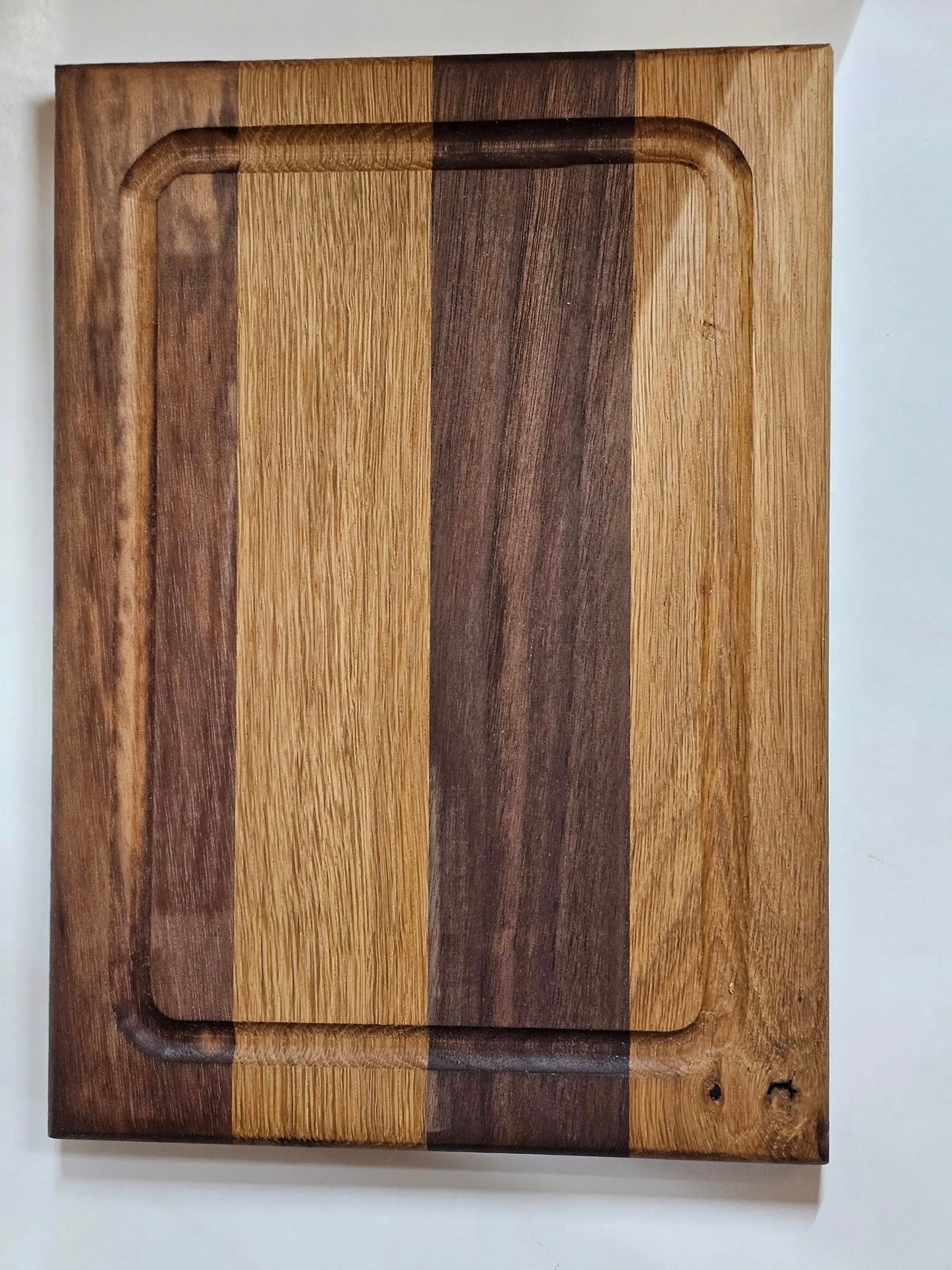 Dark American walnut and white oak cutting board. Small