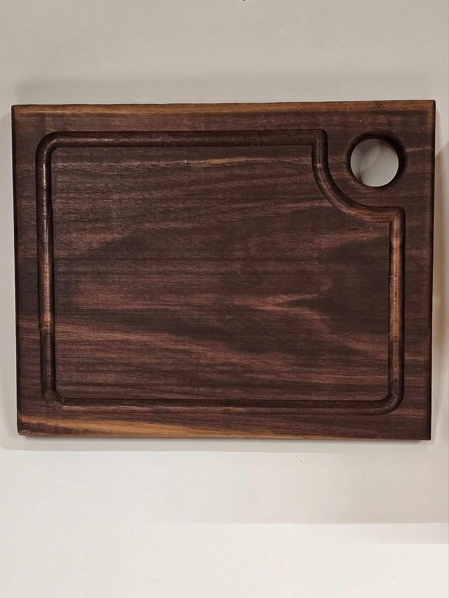 Dark American walnut cutting board. Medium size