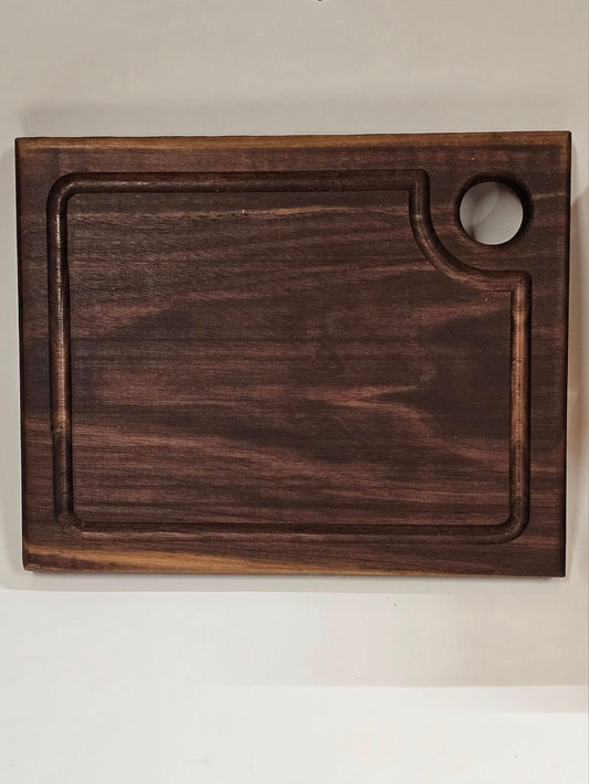 Dark American walnut cutting board. Medium size